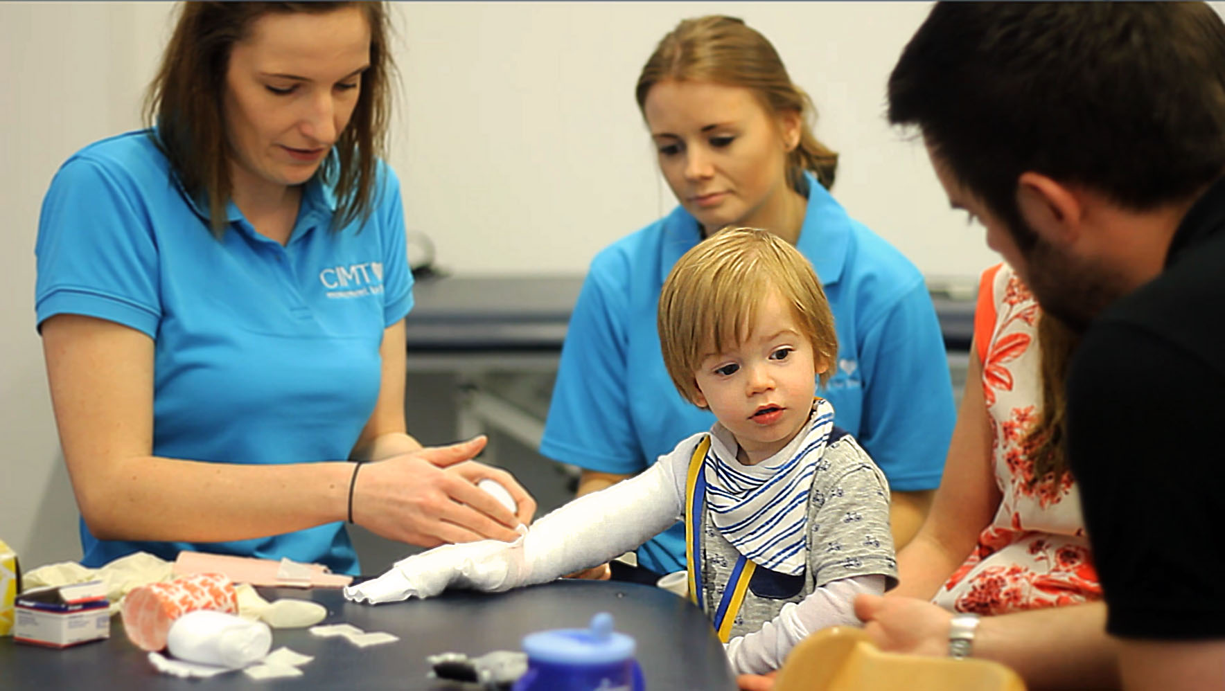 Parents with son during CIMT therapy.