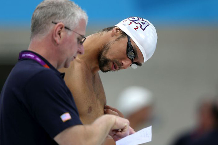 Swimmer looking at coach's notes.
